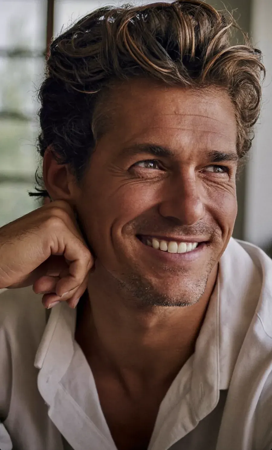 Man with thick curly hair smiling