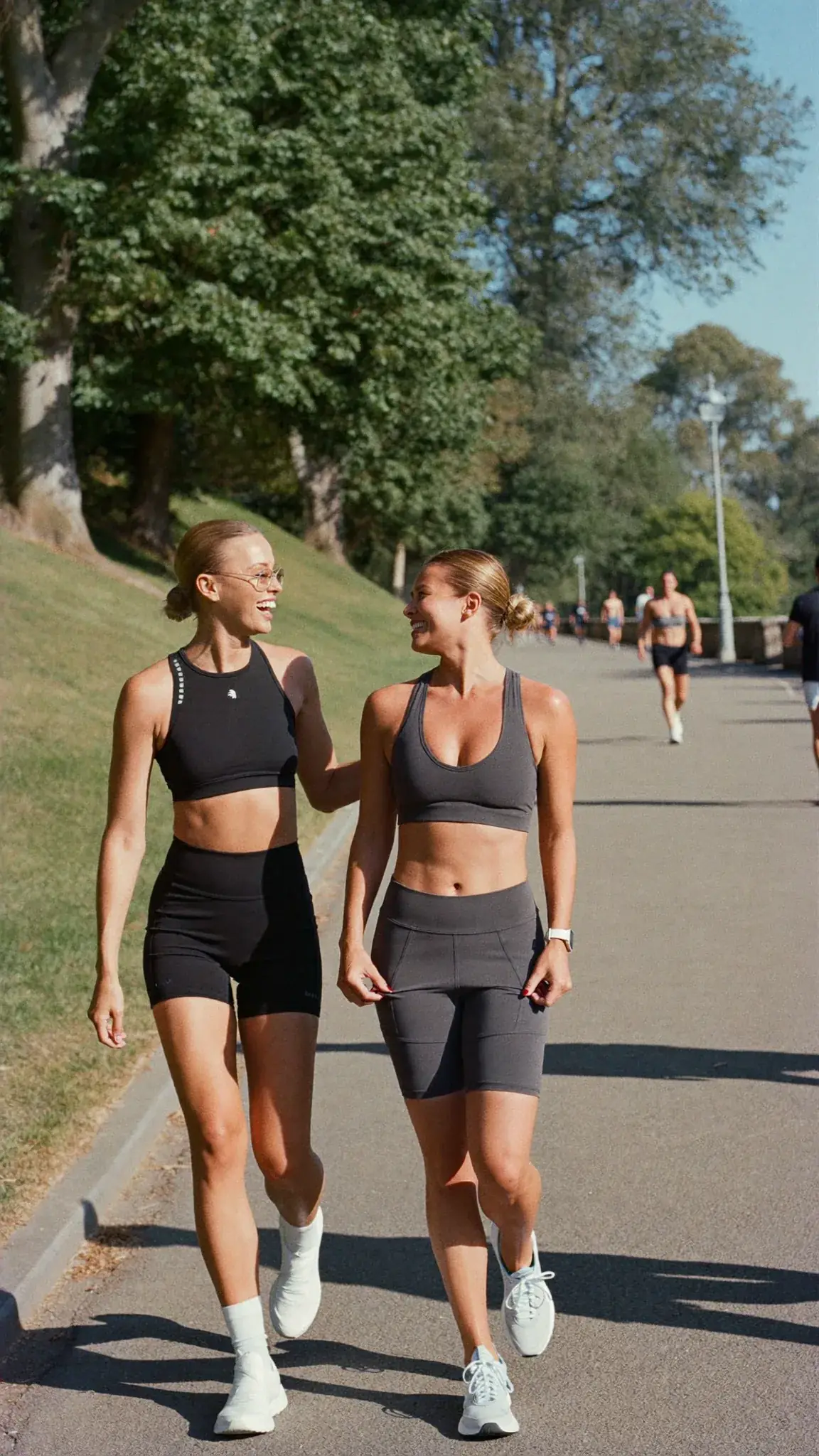 Two women walking together in a park