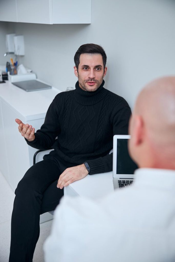 handsome-man-talking-with-doctor-clinic